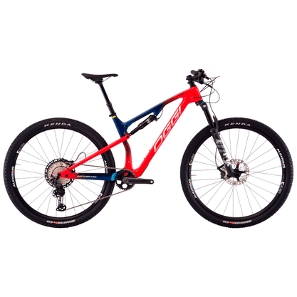 Bicicleta Oggi Cattura Pro T-20 Carbon Aro 29 XT 12v 2023 Vermelho e Azul